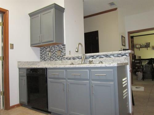 New tile backsplash and beautiful countertops installed for a clean, updated kitchen.
