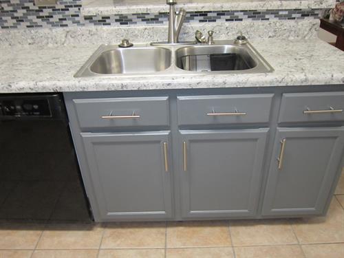 Fresh countertops and refinished cabinets give this kitchen a bright, modern look.