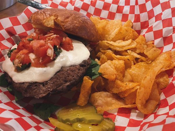 Enjoy bites from our small menu including this Caprese burger. 