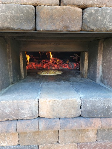 Wood-fired pizza at the Shores Patio brick oven