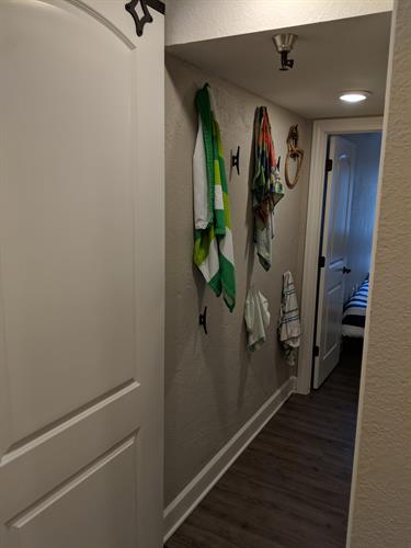 Bedroom/bathroom hallway with dock cleats as storage hooks.