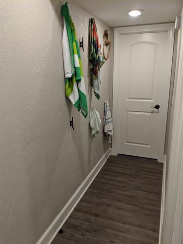 Bedroom/bathroom hallway with dock cleats as storage hooks.