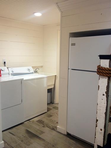 Laundry and extra shower room in basement leading to basement suite