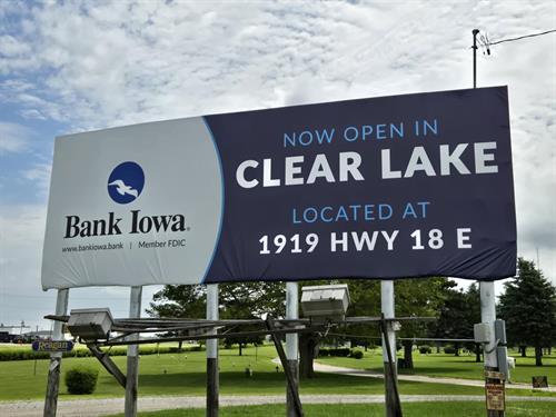Gallery Image S106157W_Bank_Iowa_D20825_R-_NOW_OPEN_IN_CLEAR_LAKE10X28_VINYL_20250623.jpg