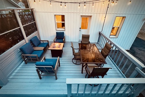 Private back deck with dining and a fire table for easy evenings at home.