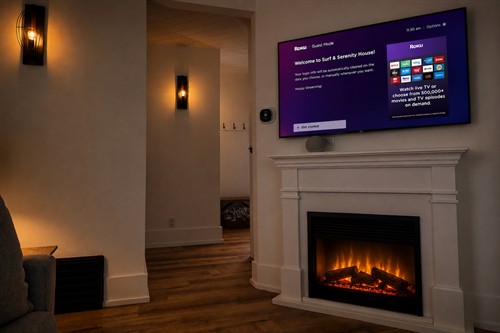 Electric fireplace glowing, 55-inch Roku ready. This is a good night in.