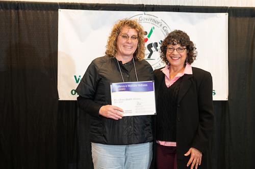 HR coordinator receiving an award from the State of Vermont.  