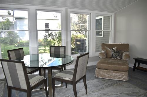 Sunroom with marble floor and view of gardens