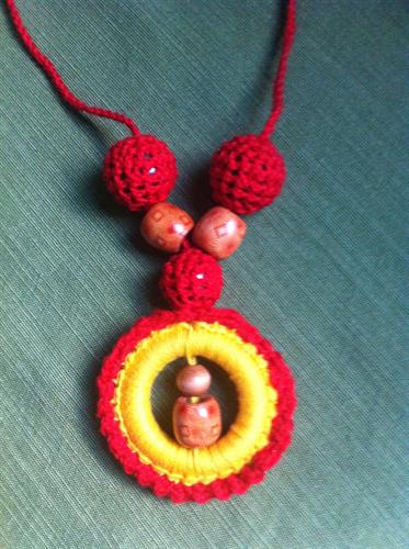 Necklaces also come with wooden beads and hoops covered by crocheted yarn.
