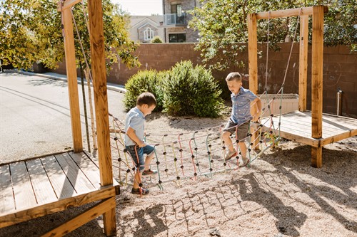 Two learners playing outside at Acton Academy St. George