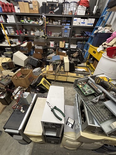 Processing a pile of desktops with more electronics in the queue.