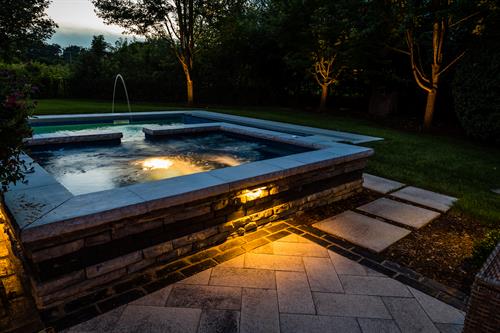 A beautiful wrap around this hot tub - including recessed lighing - makes it an inviting spot, day or night.