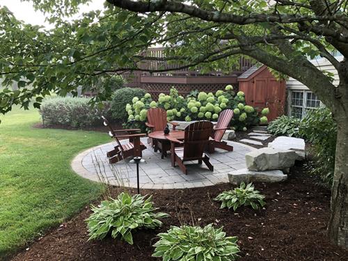 An intimate seating area nestled into the landscape creates a relaxing retreat.