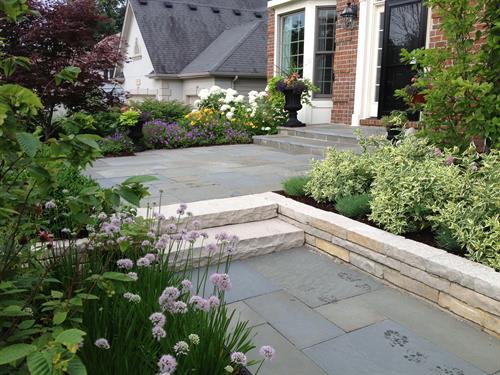 Stunning plants and beautiful hardscape create a welcoming entry.