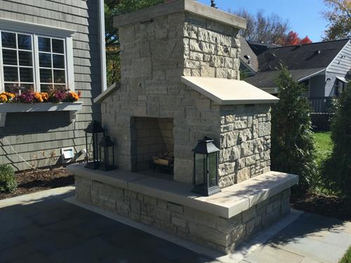 This stone masonry fireplace is a showstopper in this backyard.