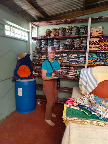 Looking at the colorful “Pad for Her” kits ready for distribution.