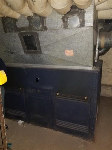 Huge furnace with asbestos lined ducts
