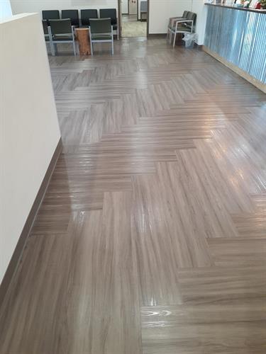 Deep cleaning/machine scrubbing and then applying finish designed for LVT makes floors easier to mop and adds some gloss. We do this process in some high traffic lobbies once/yr. Deep cleaning/machine scrubbing and then applying finish designed for LVT makes floors easier to mop and adds some gloss. We do this process in some high traffic lobbies once/yr.