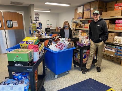 Jack Hartigan, Owner and CEO of Hartigan Lawn and Landscaping, LLC. pictured with a volunteer/member from 360 Communities Rosemount Family Resource Center a non-profit organization helping families that are in need. 