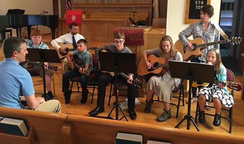 Getting ready for a guitar group performance at our music recital!