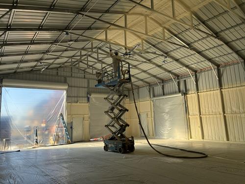 Professional closed-cell spray foam installation on a metal building for durability, air sealing, and energy savings.