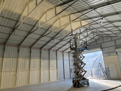 Closed-cell spray foam insulation applied to a metal structure—ideal for moisture resistance and temperature control.