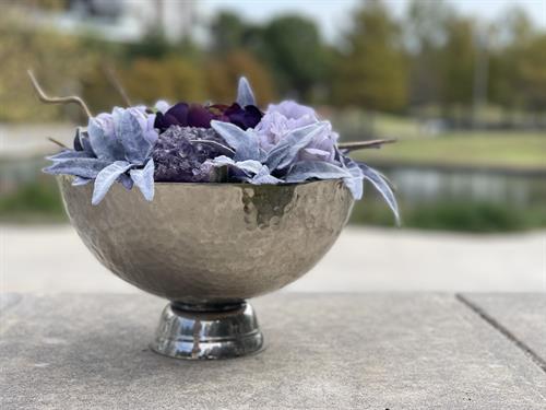 This flower arrangement showcases a unique and sophisticated stainless steel base, with an eye-catching amethyst gray-purple crystal at its center.