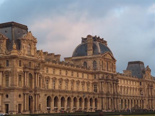 France Paris Louvre Facade Glowing in Sunset
