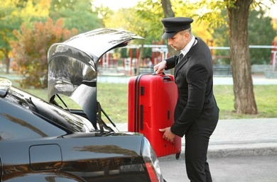 Gallery Image chauffeur-putting-suitcase-car-trunk-260nw-543933064.jpg