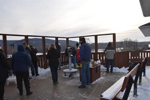 people observing bald eagles by the wisconsin river