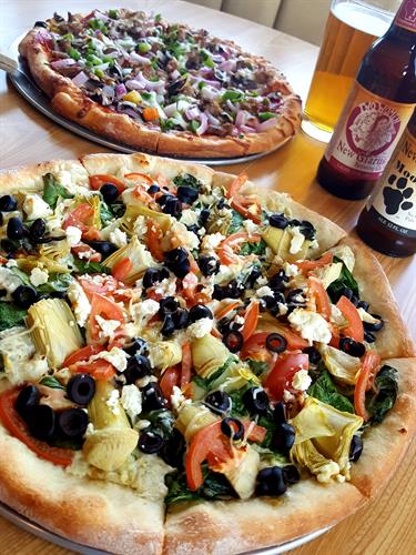 two pizzas and beer at Riviera Bowl & Pizzeria