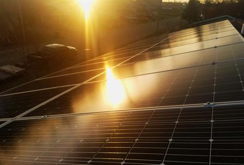 sun rays reflecting on solar panels