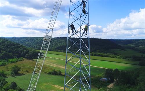 men climbing up a tower