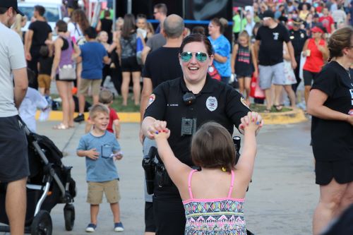 Police Officer high fives girl at National Night Out 2019