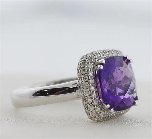 This 4.04 carat grape purple amethyst is an amazing color and has been cut in to a plump square cushion shape. It is surrounded by a pave set diamond halo.