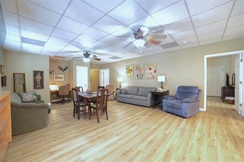 Great room with 1 sleeper sofa and 1 couch and dining table.
