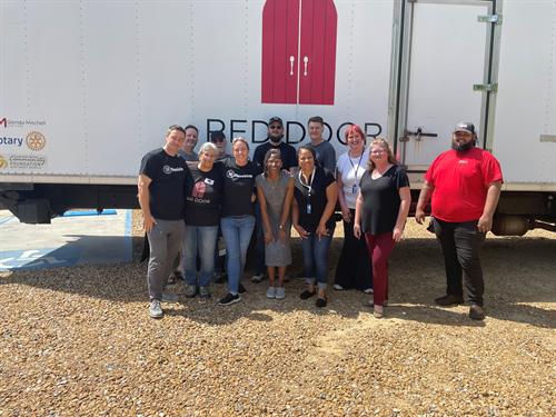 Walmart Health lends a hand to help unload the food truck for the Red Door Pantry