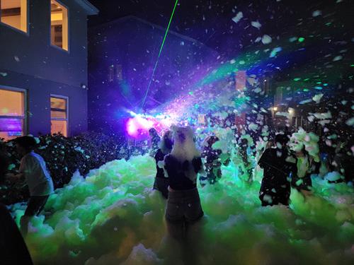 Nighttime foam party with lasers, lights, fog, and glow foam