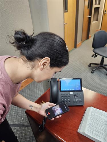 Receptionist with door camera feed on mobile