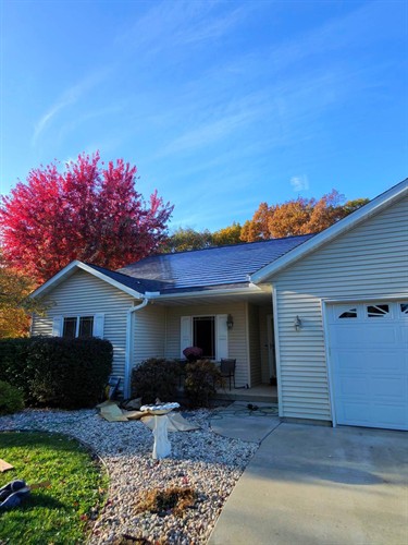 These low profile solar shingles quietly power the home while preserving a classic roofline.