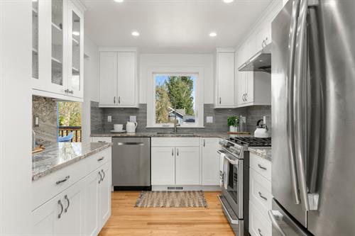 Handsome remodel of the kitchen with steps away to a master gardener's dream yard