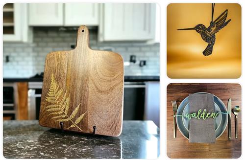 3 photos: 1. a wood cutting board with a golden fern sitting on top of a counter. 2. an ornament of a black hummingbird in front of yellow background. 3. laser-cut word WALDEN laying across a napkin on plates