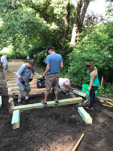 Volunteers installing steps on the east side of the park