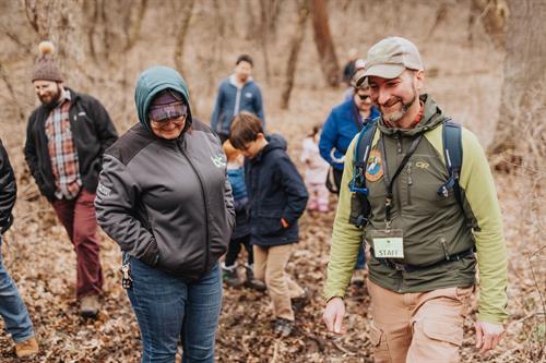 A naturalist leading a guided hike at Shepard Farm through the 100-year-old woods.