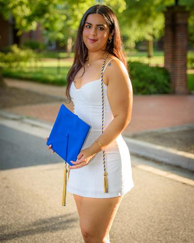 Portrait of a grad ad UD in Newark Delaware showing her cap