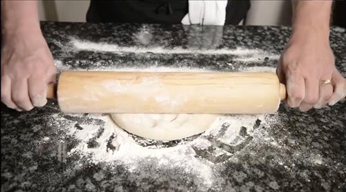 Hand rolling our dough every morning