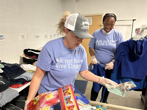 United Way Volunteers organizing donated clothing at Fay. Urban Ministry. 