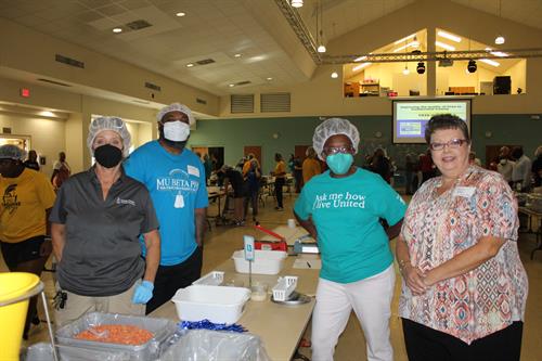 United Way Volunteers preparing to pack meals during the meal packing event. 