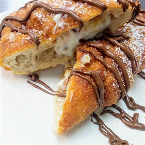 Nutella fritta: deep fried calzone stuffed with sweet ricotta from Italy, and bananas; topped with Nutella and powdered sugar