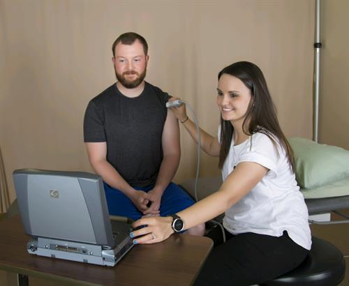 Sarah Flatt, PT, DPT uses the diagnostic ultrasound machine to check out a shoulder. 